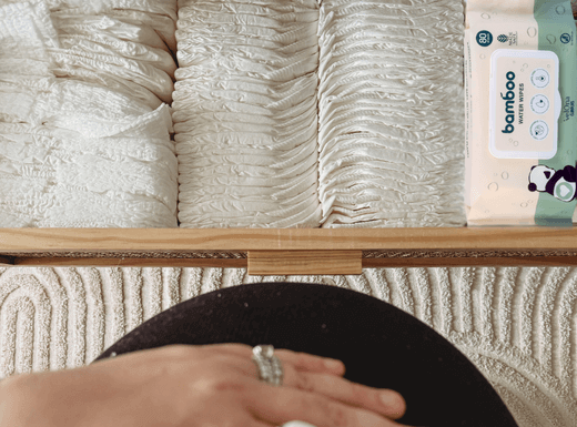 Pregnant mum next to nappies and wipes