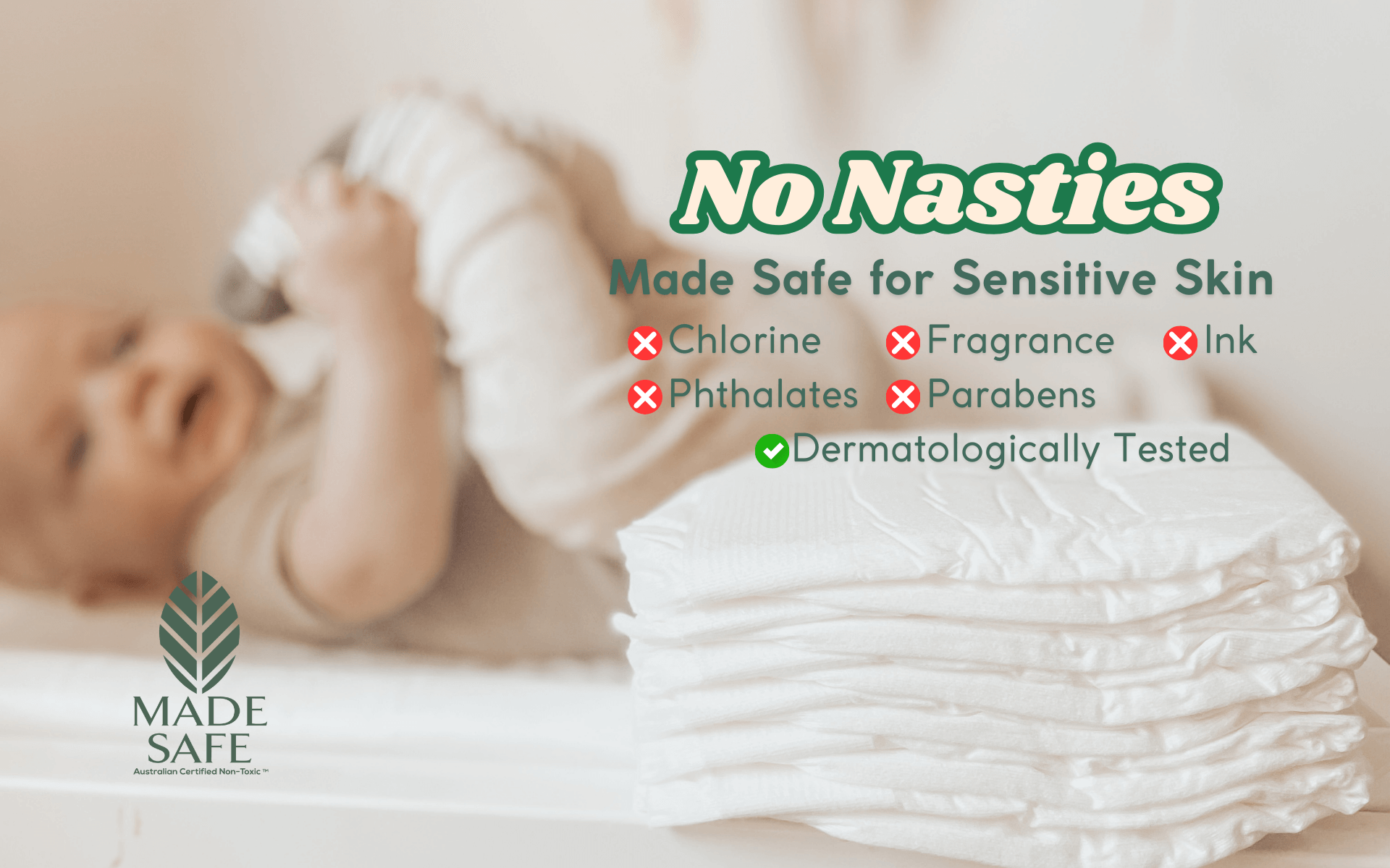 Baby lying on a stack of Cuddlies nappies with 'No Nasties' and safety features listed.