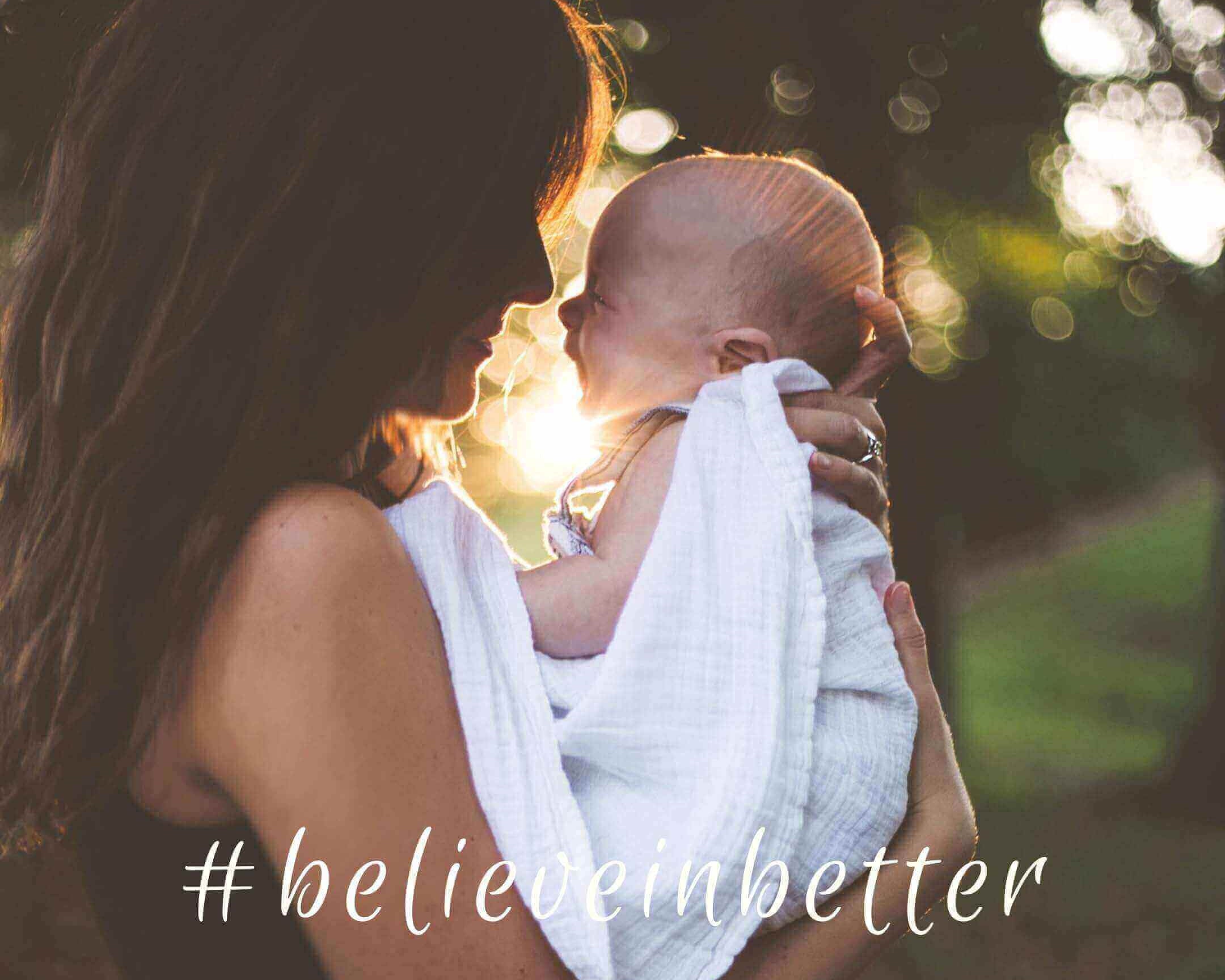 Mum holding baby with Cuddlies eco nappies - gentle, sustainable care for newborns