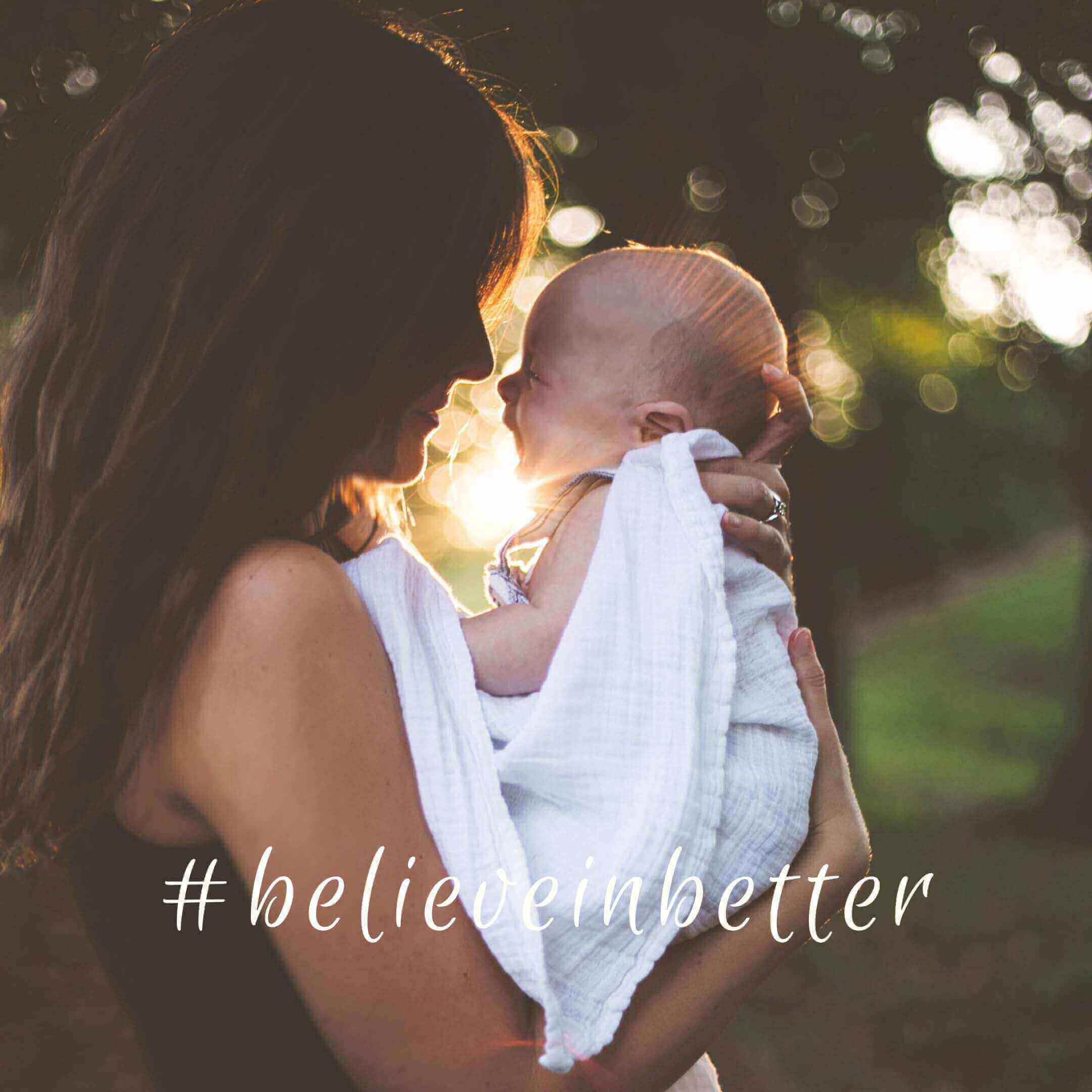Mum holding baby with Cuddlies eco nappies - gentle, sustainable care for newborns