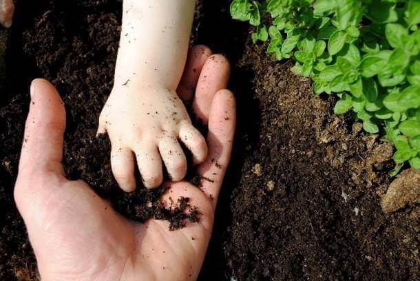 baby playing with soil