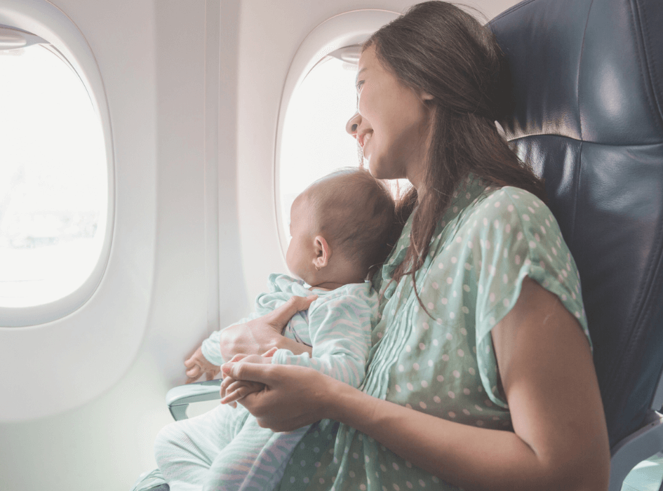 Baby and mum on a plane travelling with a baby and toddler