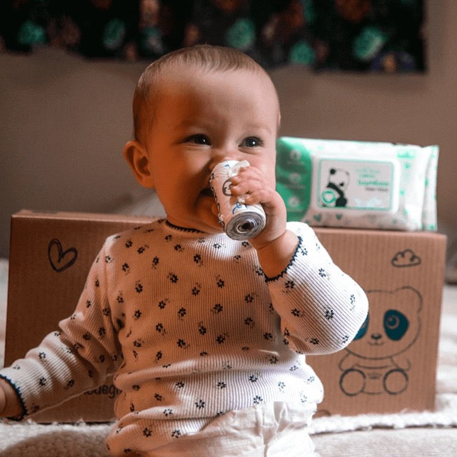 cuddlies baby holding eco nappy disposal bags roll