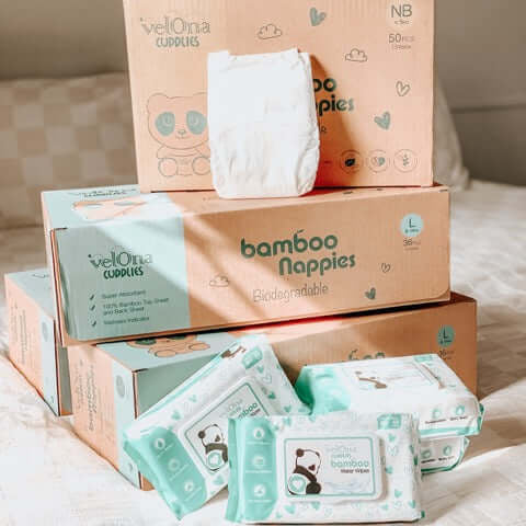 Cuddlies subscription bundle of nappies and water wipes on the bed